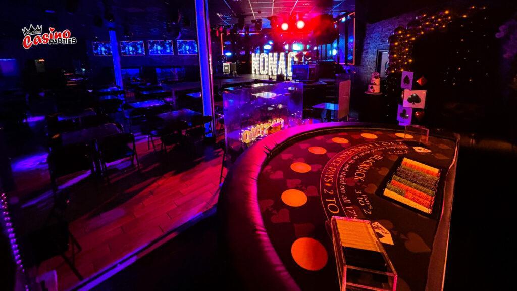Professional blackjack table with chips at a neon-lit themed casino party rentals Tampa experts!.