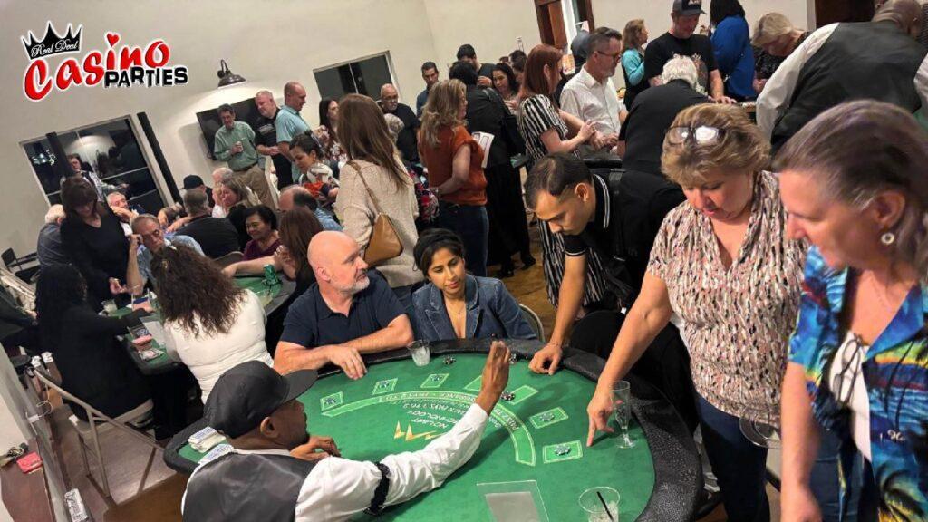 Casino party rental setup in Florida with blackjack tables, roulette wheel, and professional dealers for corporate and private events.
